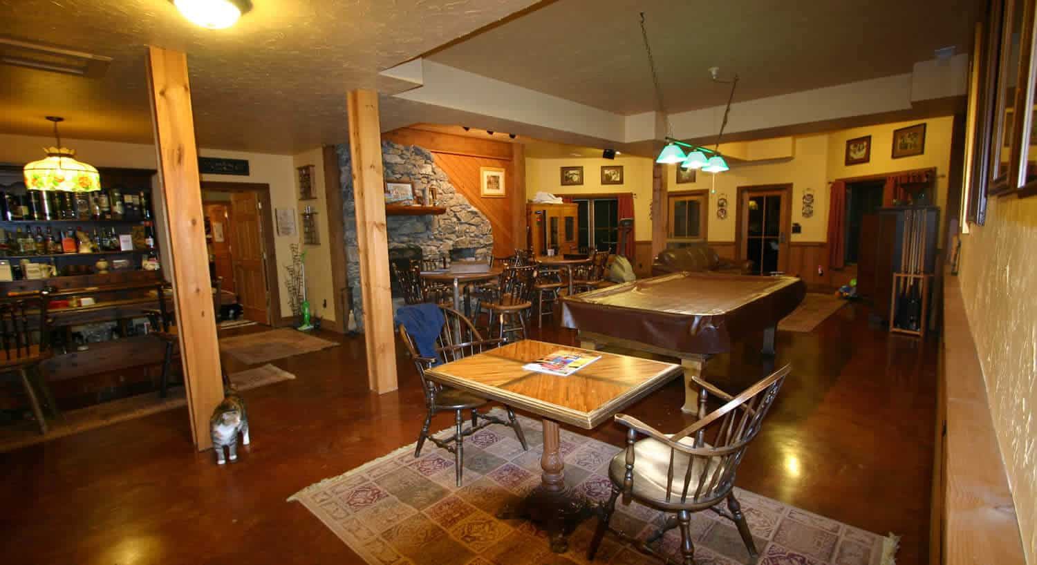 Game room at Wildberry Lodge with pool table and stone fireplace