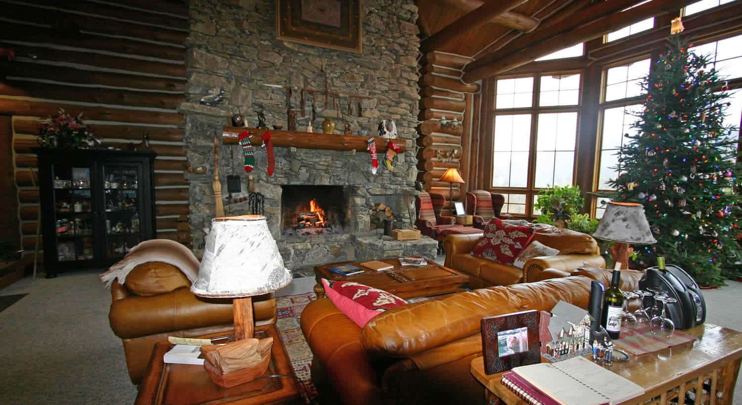The Great Room at Wildberry Lodge with its stone fireplace and leather sofas