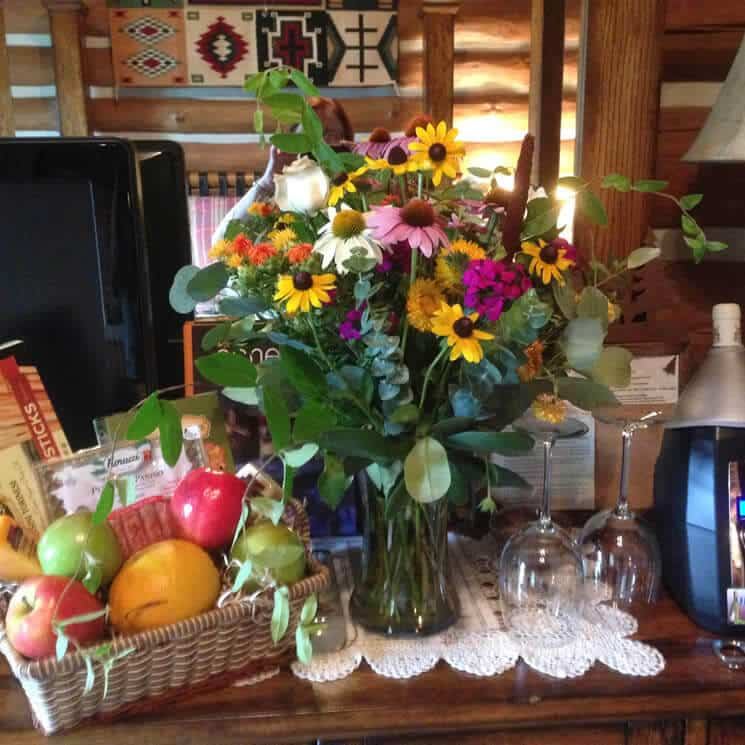 Fresh flowers and fruit waiting in a Wildberry Lodge room